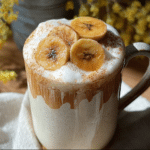 Banana Bread Latte in a rustic mug with cinnamon and banana slice garnish